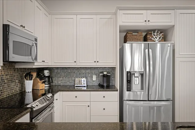 a kitchen with a refrigerator and cabinets