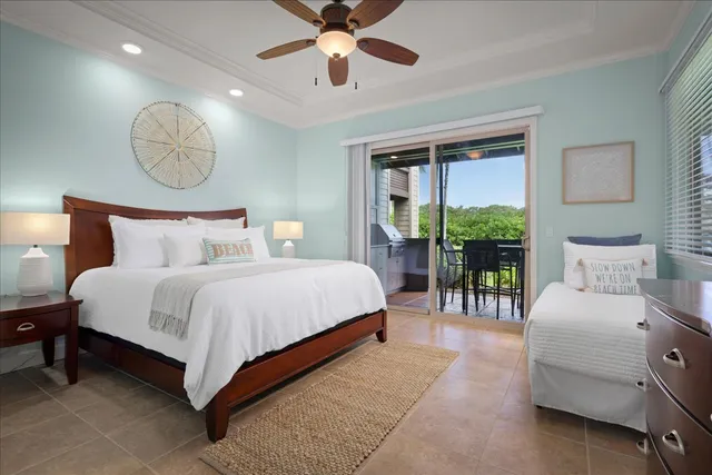 a bedroom with a bed mirror and a large window