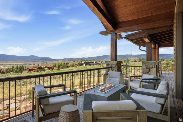 7885 North Rabbitbrush Court, Unit 13 Park City, UT 84098 - Photo 69 of 88 Expansive outdoor deck featuring a built-in fire pit and a sturdy metal railing