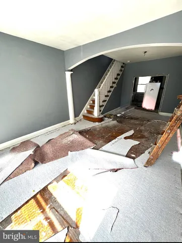 a view of a hall with floor to ceiling window and a rug