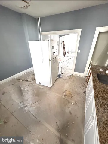 a view of a living room with furniture and wooden floor