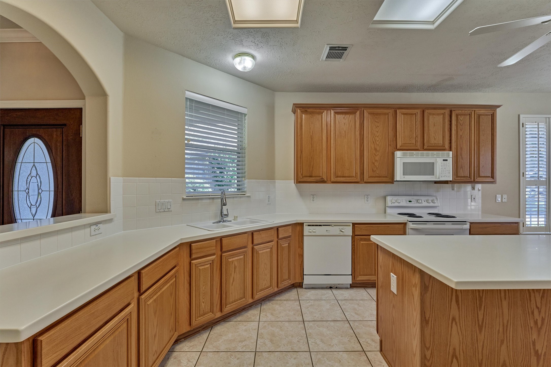 175 West Lilac Ridge Place The Woodlands, TX 77384 - Photo 11 of 31 a kitchen with a sink stove and cabinets