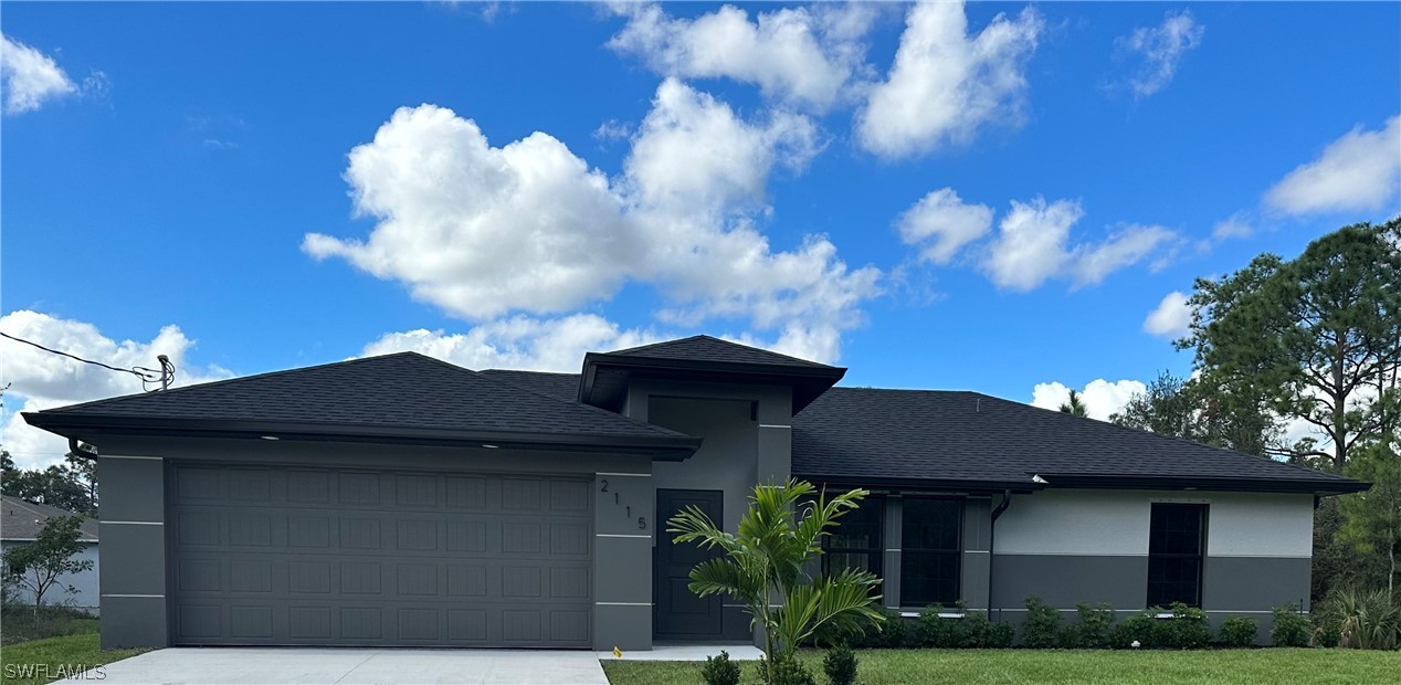 2115 Robert Avenue Alva, FL 33920 - Photo 1 of 11 a front view of a house with a garden