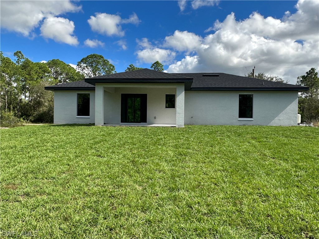 2115 Robert Avenue Alva, FL 33920 - Photo 11 of 11 a front view of a house with a garden