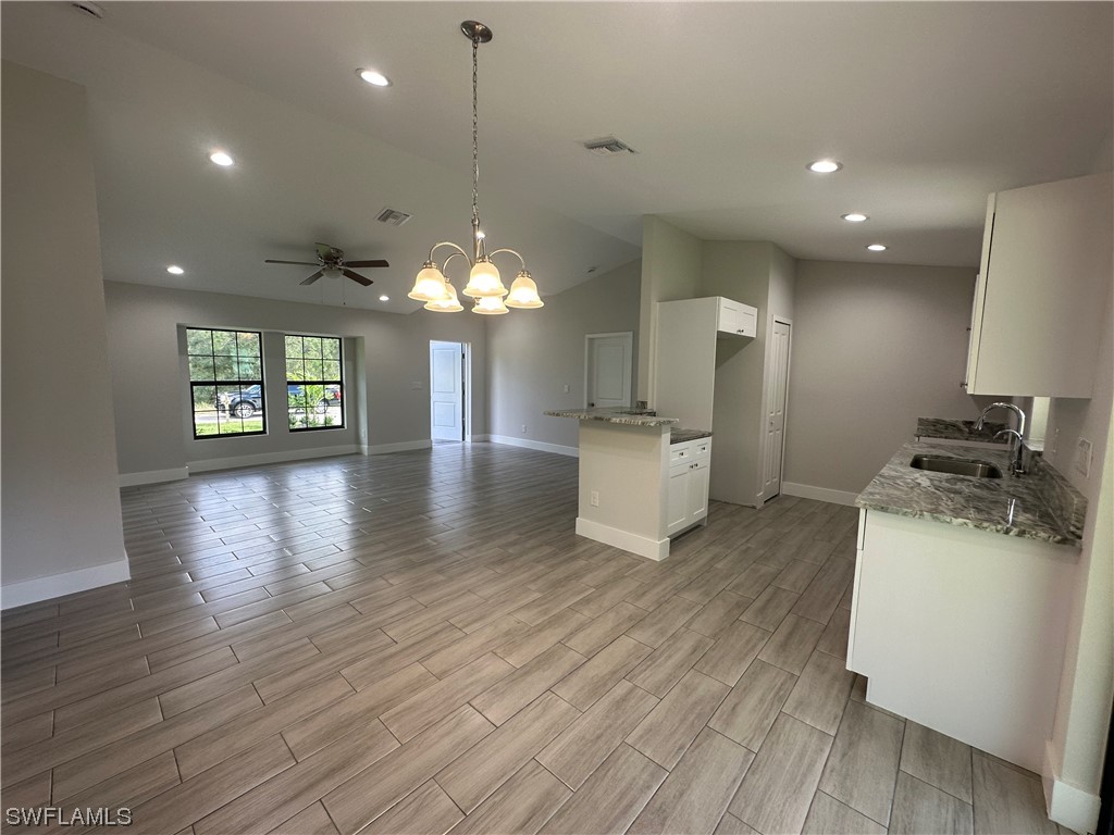 2115 Robert Avenue Alva, FL 33920 - Photo 3 of 11 a view of a kitchen with a sink a kitchen view and a window