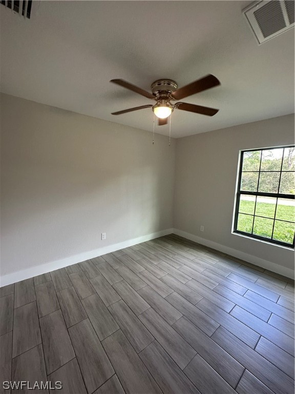 2115 Robert Avenue Alva, FL 33920 - Photo 4 of 11 an empty room with wooden floor chandelier fan and windows