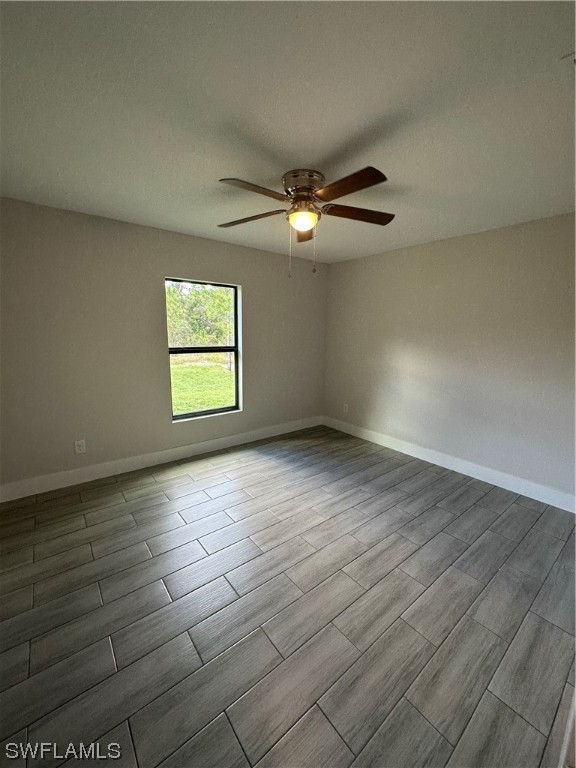 2115 Robert Avenue Alva, FL 33920 - Photo 6 of 11 an empty room with wooden floor chandelier fan and windows