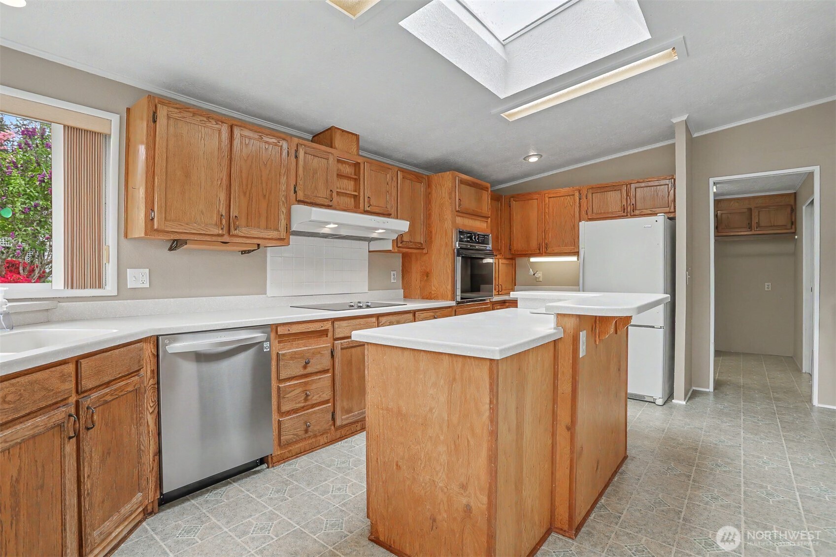 905 243rd Street Southwest Bothell, WA 98021 - Photo 3 of 37 a kitchen with a sink stove and cabinets