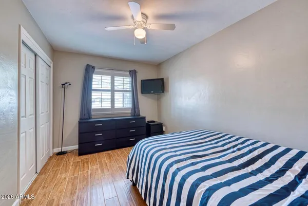 a bedroom with a bed and a painting on the wall