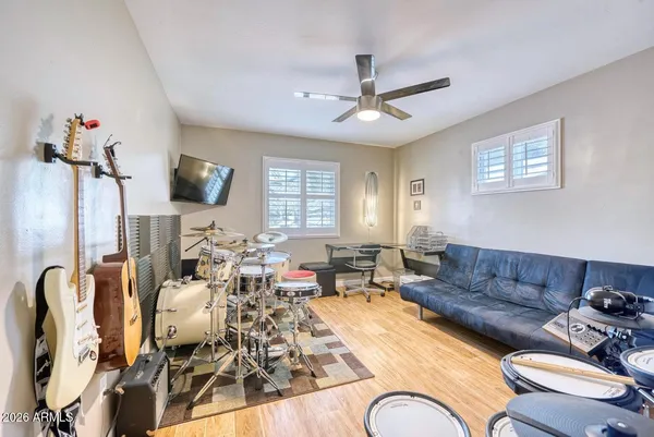a bathroom with a granite countertop sink a mirror and a shower