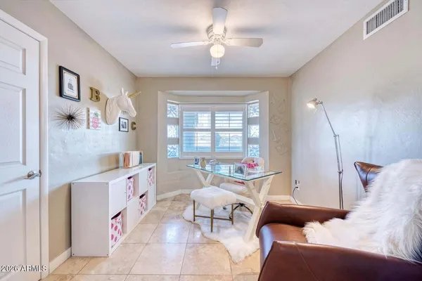 a living room with furniture kitchen view and a window
