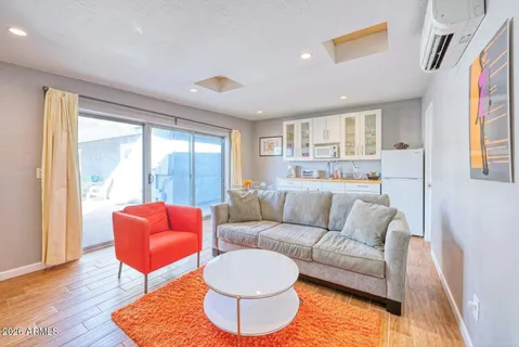 a spacious bathroom with a tub sink and mirror