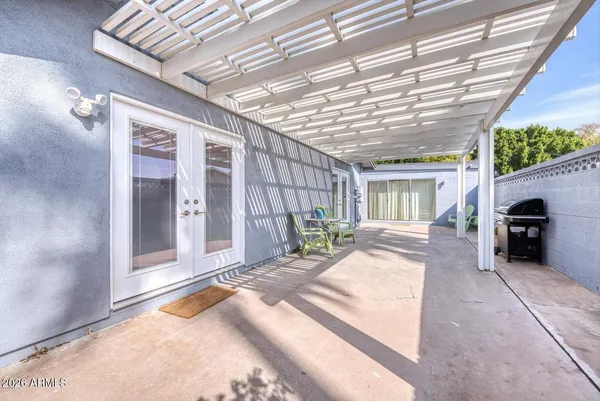 a bathroom with a toilet sink vanity granite tub and mirror