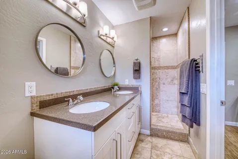 a bedroom with a large bed and a flat screen tv