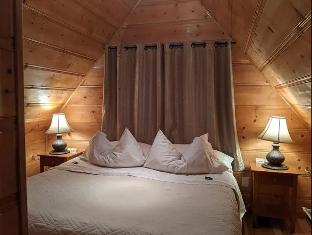 a bedroom with a bed and a lamp with potted plants