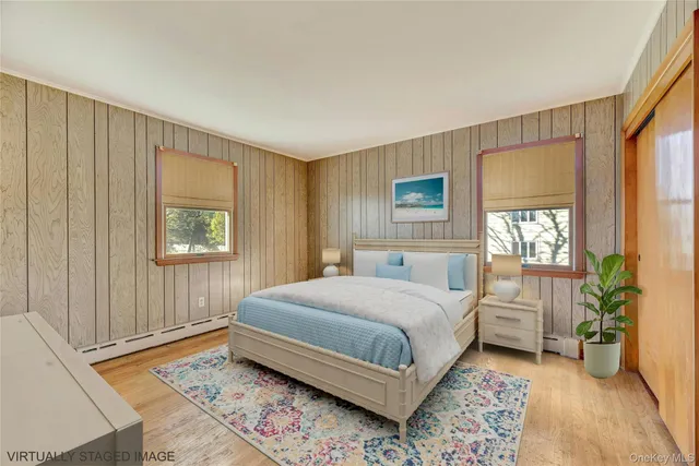 a bedroom with a large bed and a window