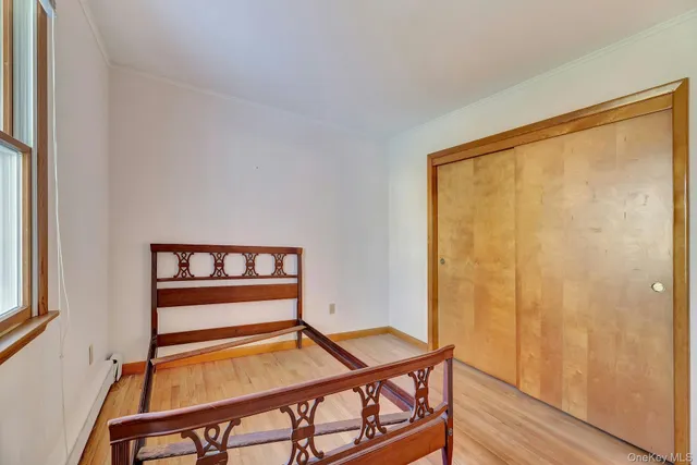 a view of a room with chairs and wooden floor