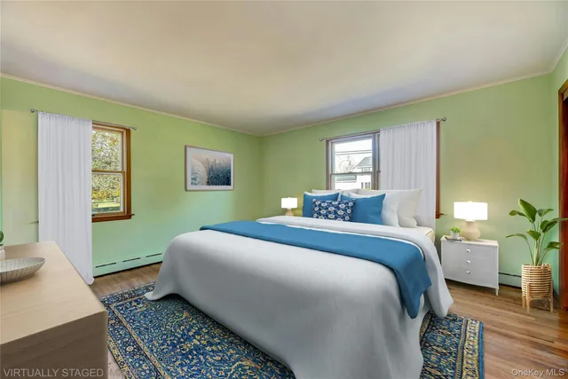 a bedroom with a bed lamp and a potted plant