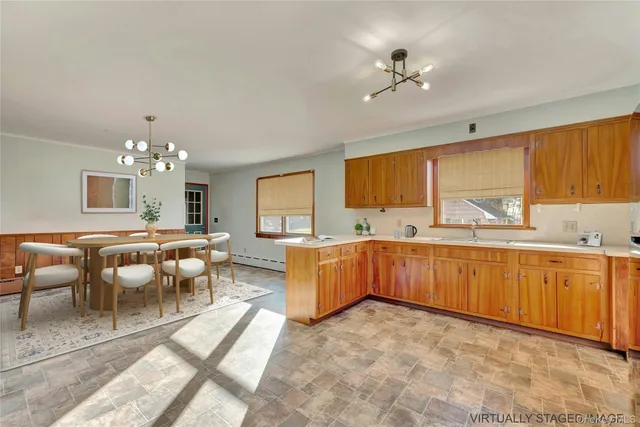 a large white kitchen with a large window