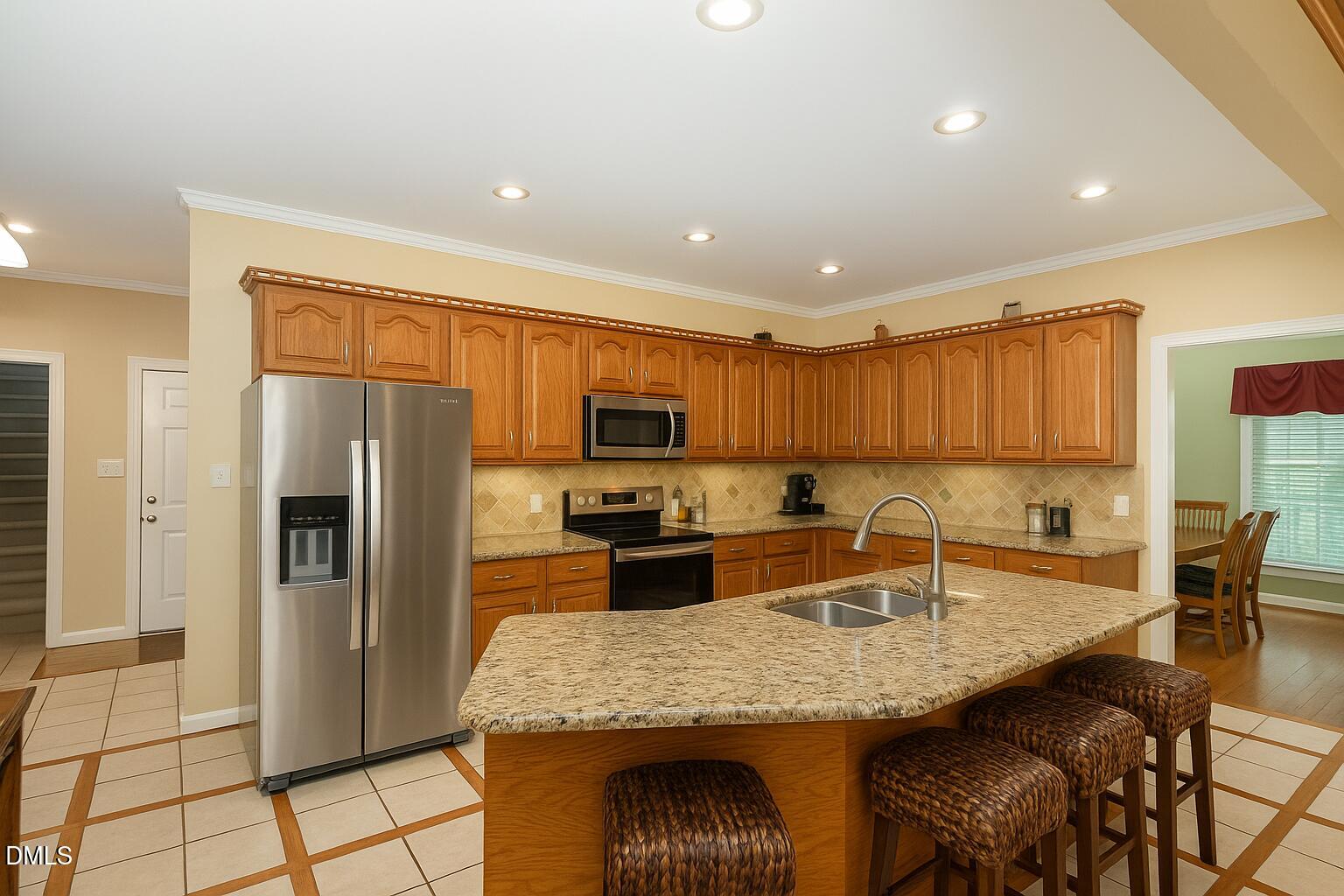 6018 West Tom Parham Road Oxford, NC 27565 - Photo 10 of 36 a kitchen with stainless steel appliances granite countertop a sink refrigerator and cabinets