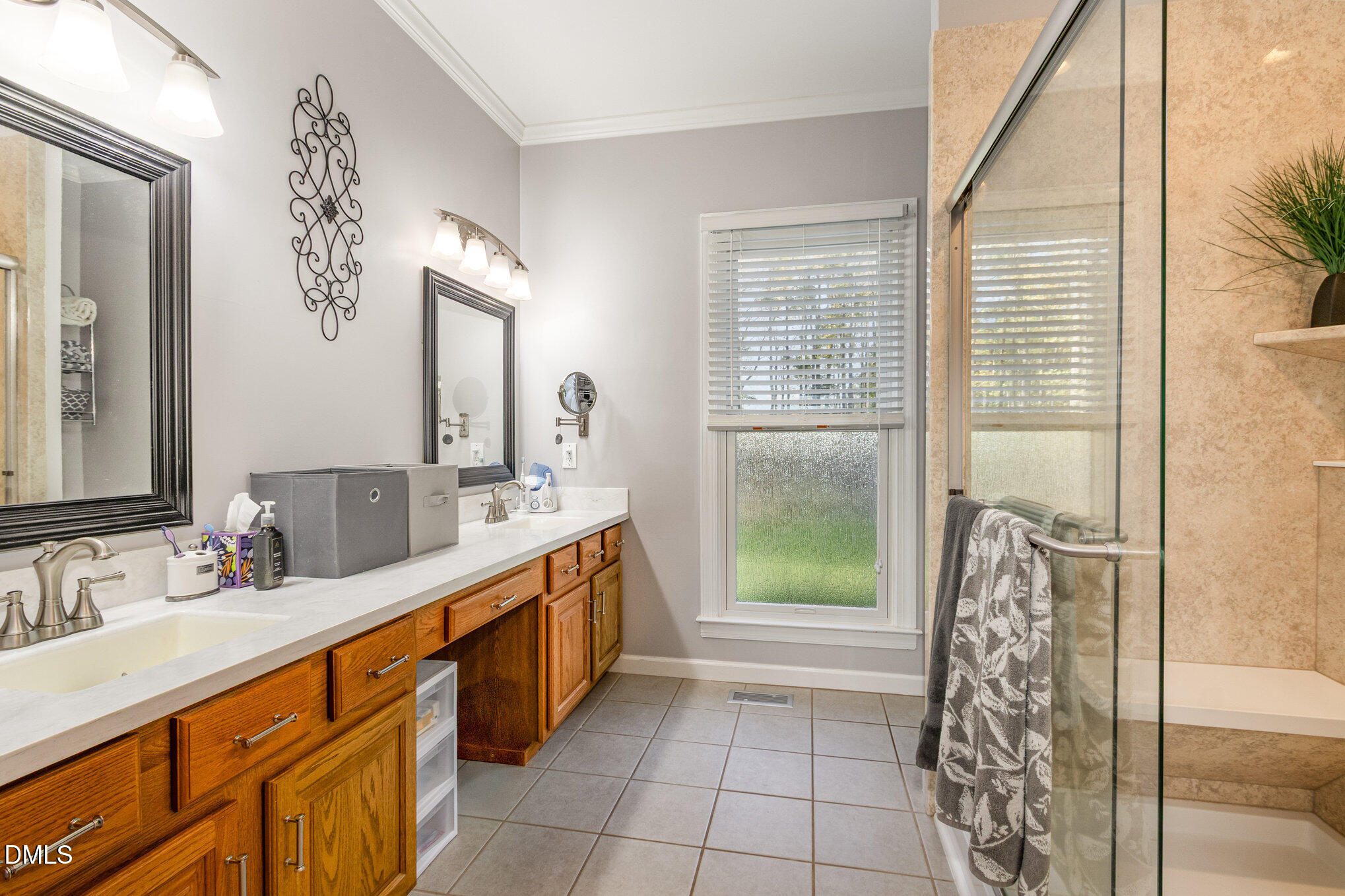 6018 West Tom Parham Road Oxford, NC 27565 - Photo 23 of 36 a bathroom with a double vanity sink a large mirror and