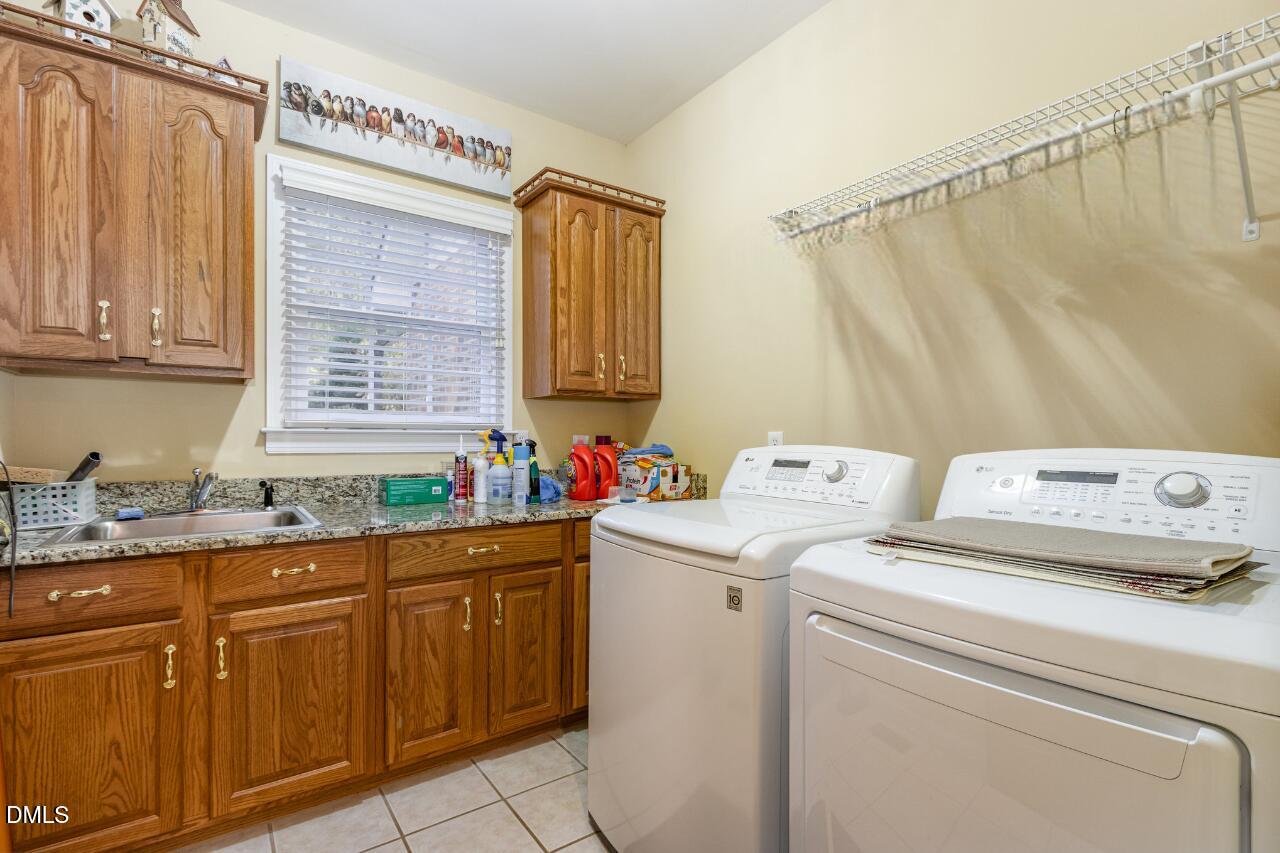 6018 West Tom Parham Road Oxford, NC 27565 - Photo 27 of 36 a utility room with closet dryer and washer
