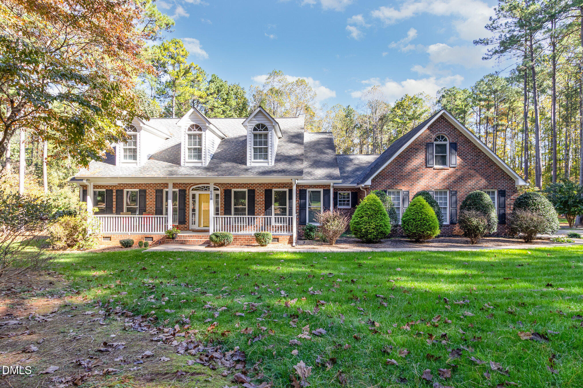 6018 West Tom Parham Road Oxford, NC 27565 - Photo 2 of 36 a front view of a house with a yard table and chairs