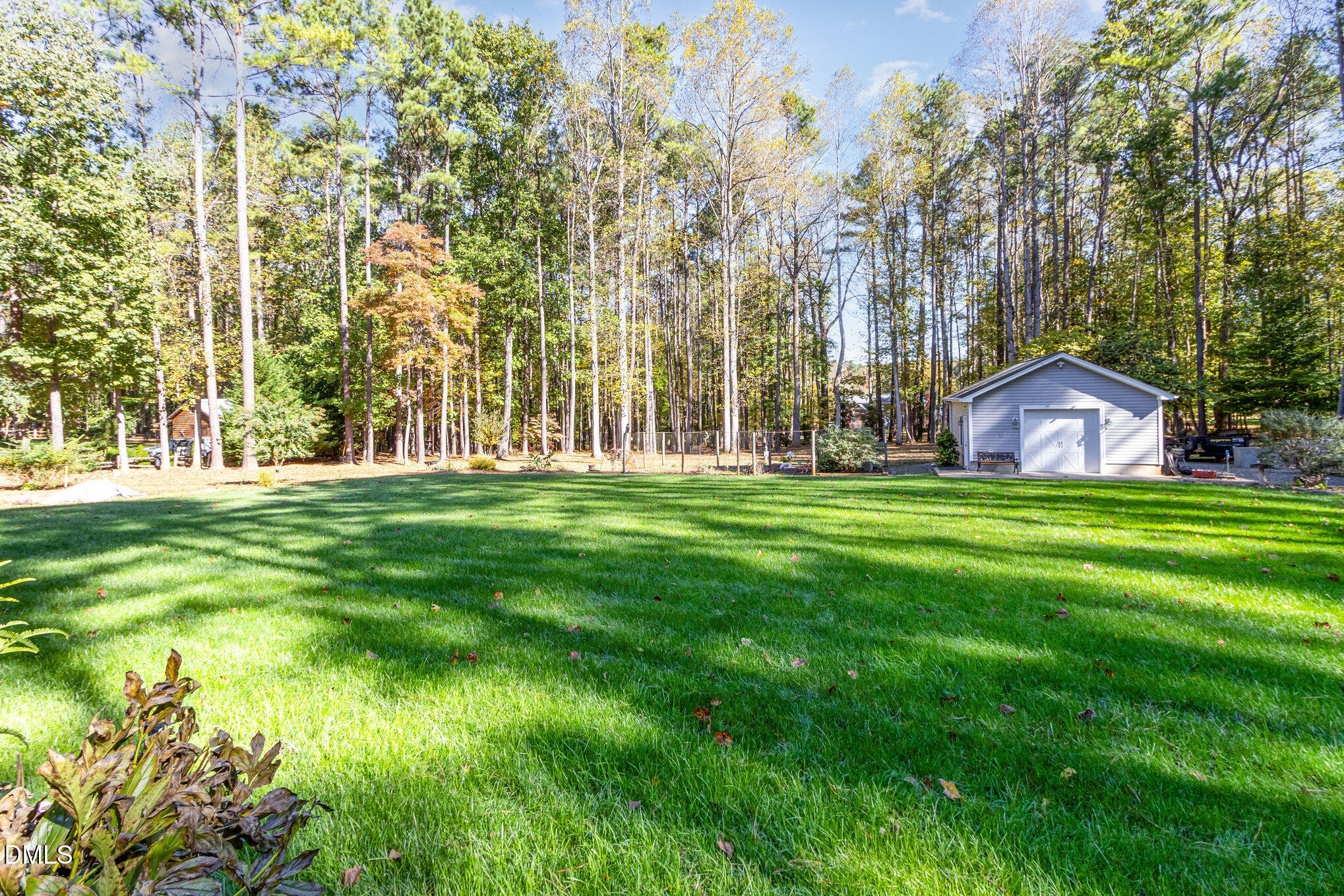 6018 West Tom Parham Road Oxford, NC 27565 - Photo 32 of 36 a backyard of a house with lots of green space and fountain