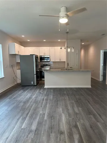 a view of a kitchen with a sink and refrigerator