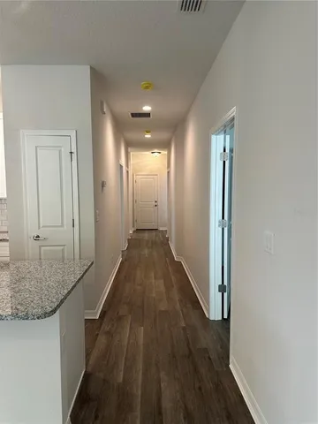 a view of hallway with wooden floor