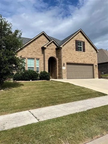 a front view of a house with a yard and balcony