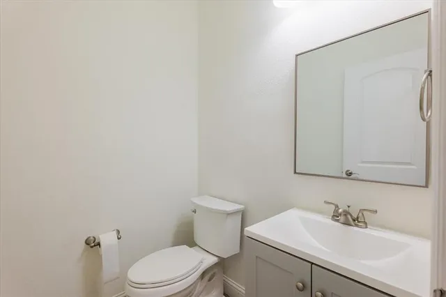 a bathroom with a sink a toilet and mirror