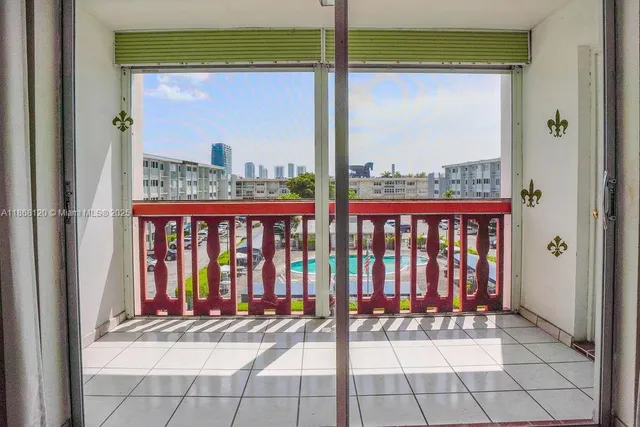 a view of a balcony with furniture and floor to ceiling window