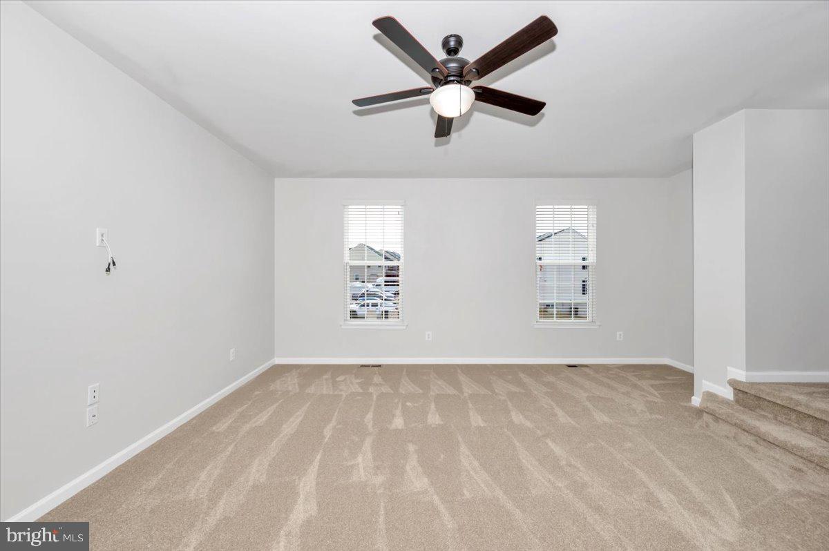 105 Montreal Way Falling Waters, WV 25419 - Photo 13 of 53 an empty room with windows and ceiling fan