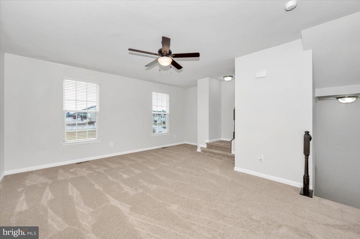 105 Montreal Way Falling Waters, WV 25419 - Photo 14 of 53 a view of a livingroom with a ceiling fan and window
