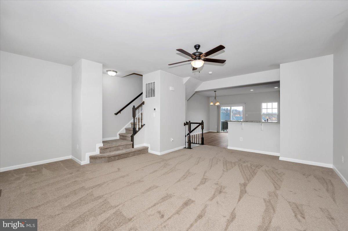 105 Montreal Way Falling Waters, WV 25419 - Photo 15 of 53 a view of empty room with wooden floor and fan