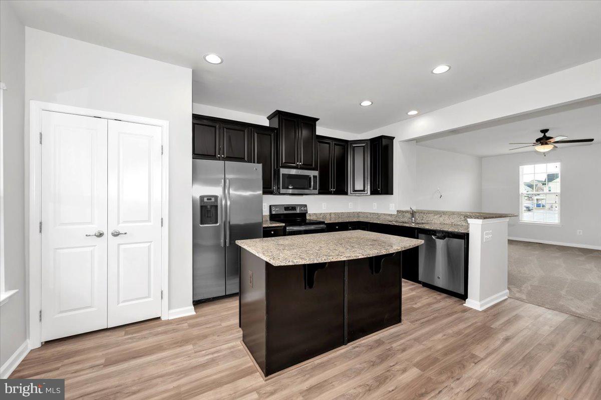 105 Montreal Way Falling Waters, WV 25419 - Photo 23 of 53 a kitchen with stainless steel appliances granite countertop a sink stove and refrigerator