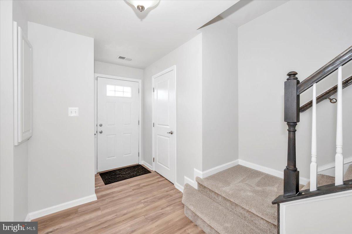 105 Montreal Way Falling Waters, WV 25419 - Photo 3 of 53 a view of a hallway with wooden floor and staircase