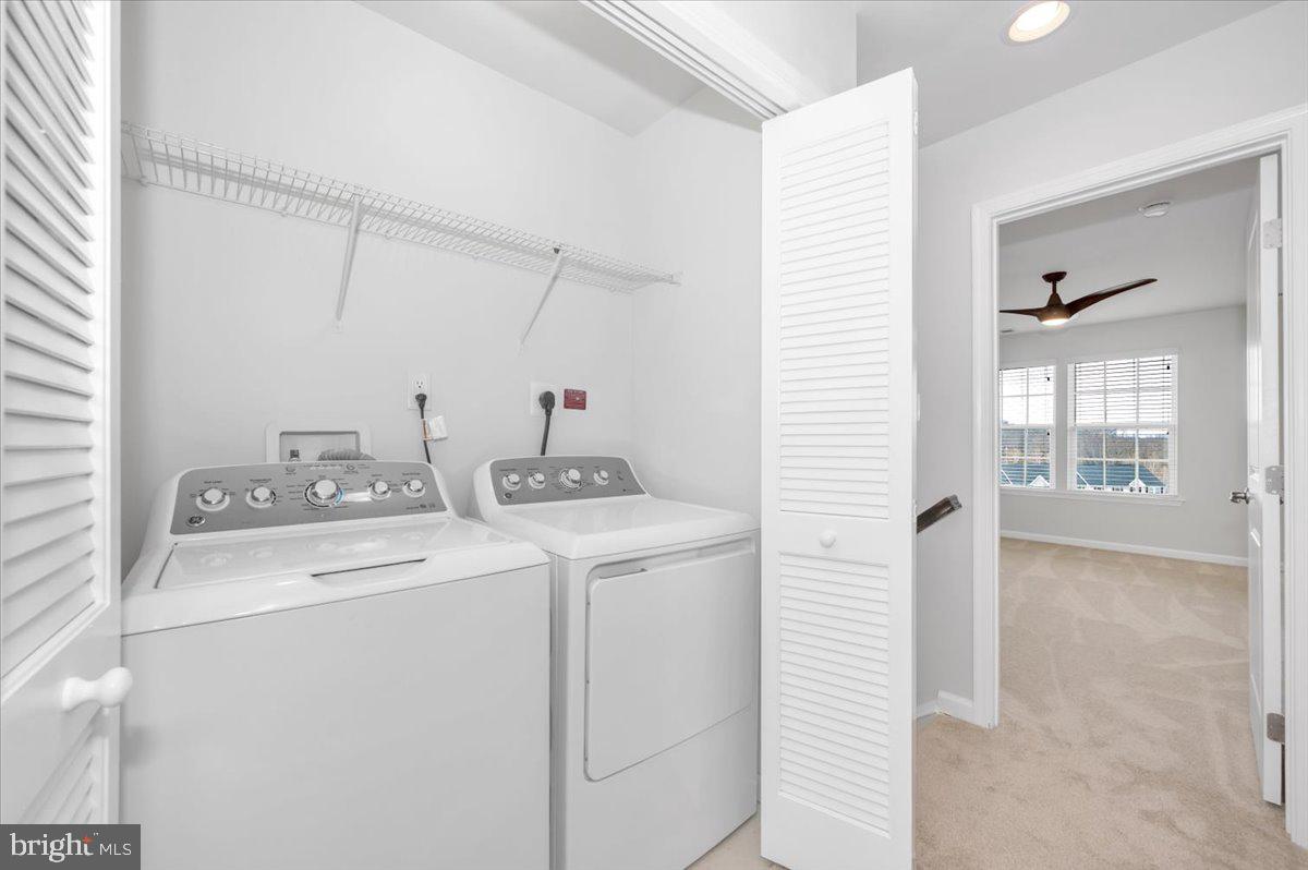 105 Montreal Way Falling Waters, WV 25419 - Photo 33 of 53 a view of washer and dryer with bathroom in the background