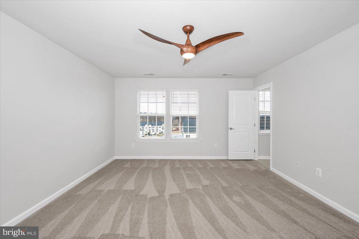 105 Montreal Way Falling Waters, WV 25419 - Photo 36 of 53 a view of empty room with wooden floor and fan