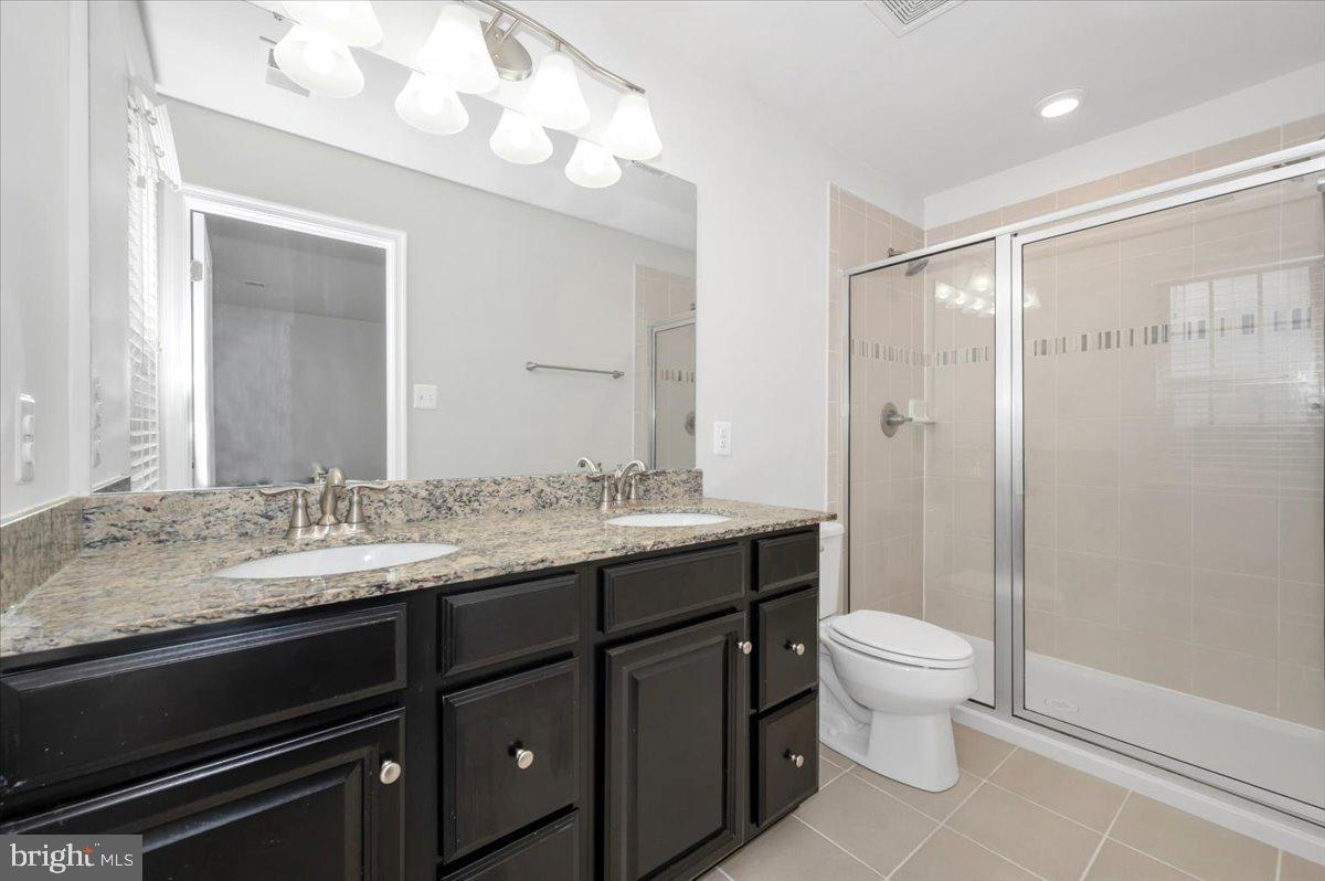 105 Montreal Way Falling Waters, WV 25419 - Photo 38 of 53 a bathroom with a granite countertop sink toilet and shower
