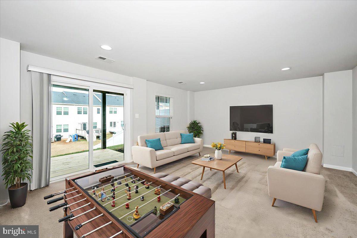 105 Montreal Way Falling Waters, WV 25419 - Photo 5 of 53 a living room with furniture and a flat screen tv