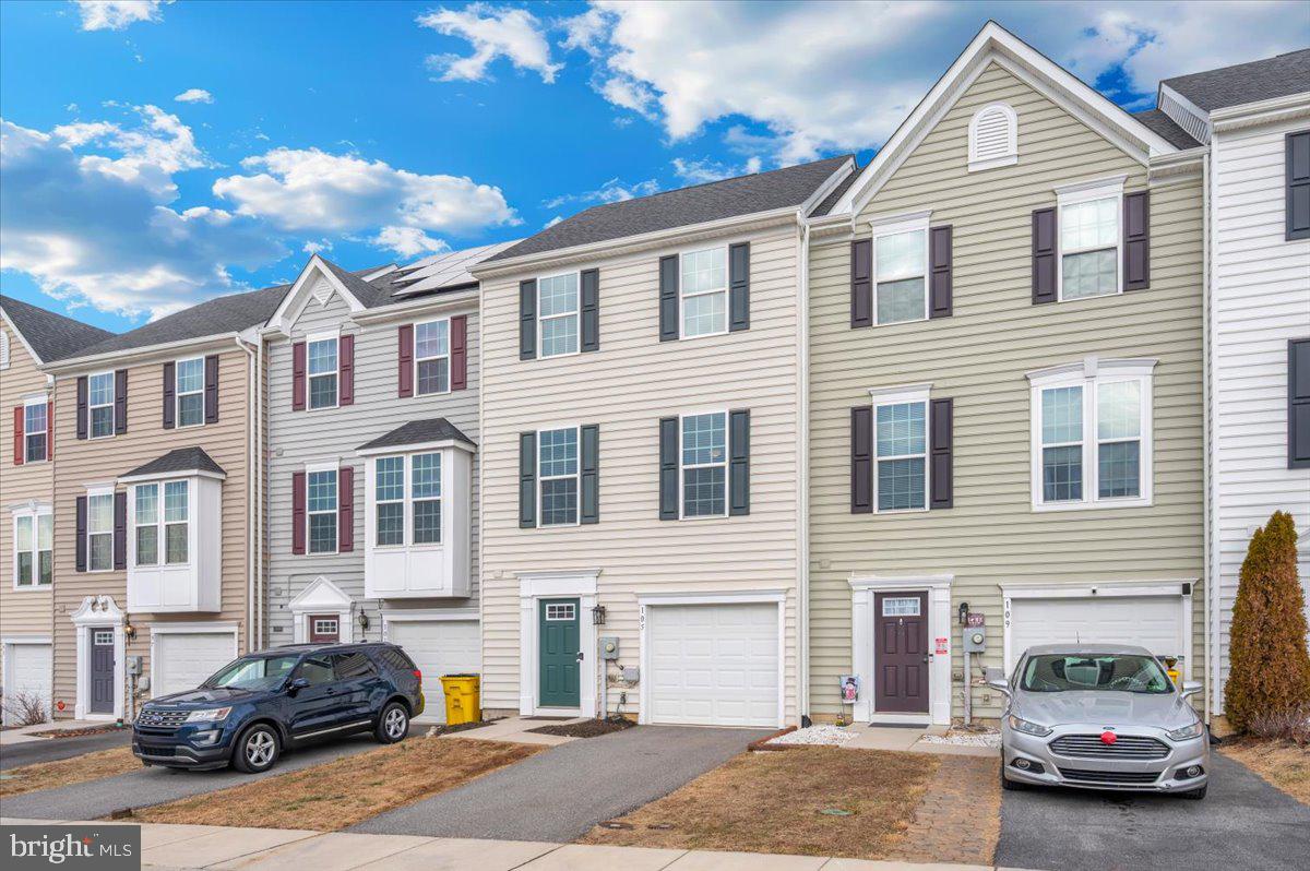 105 Montreal Way Falling Waters, WV 25419 - Photo 51 of 53 a front view of a house with parking space and a car parked