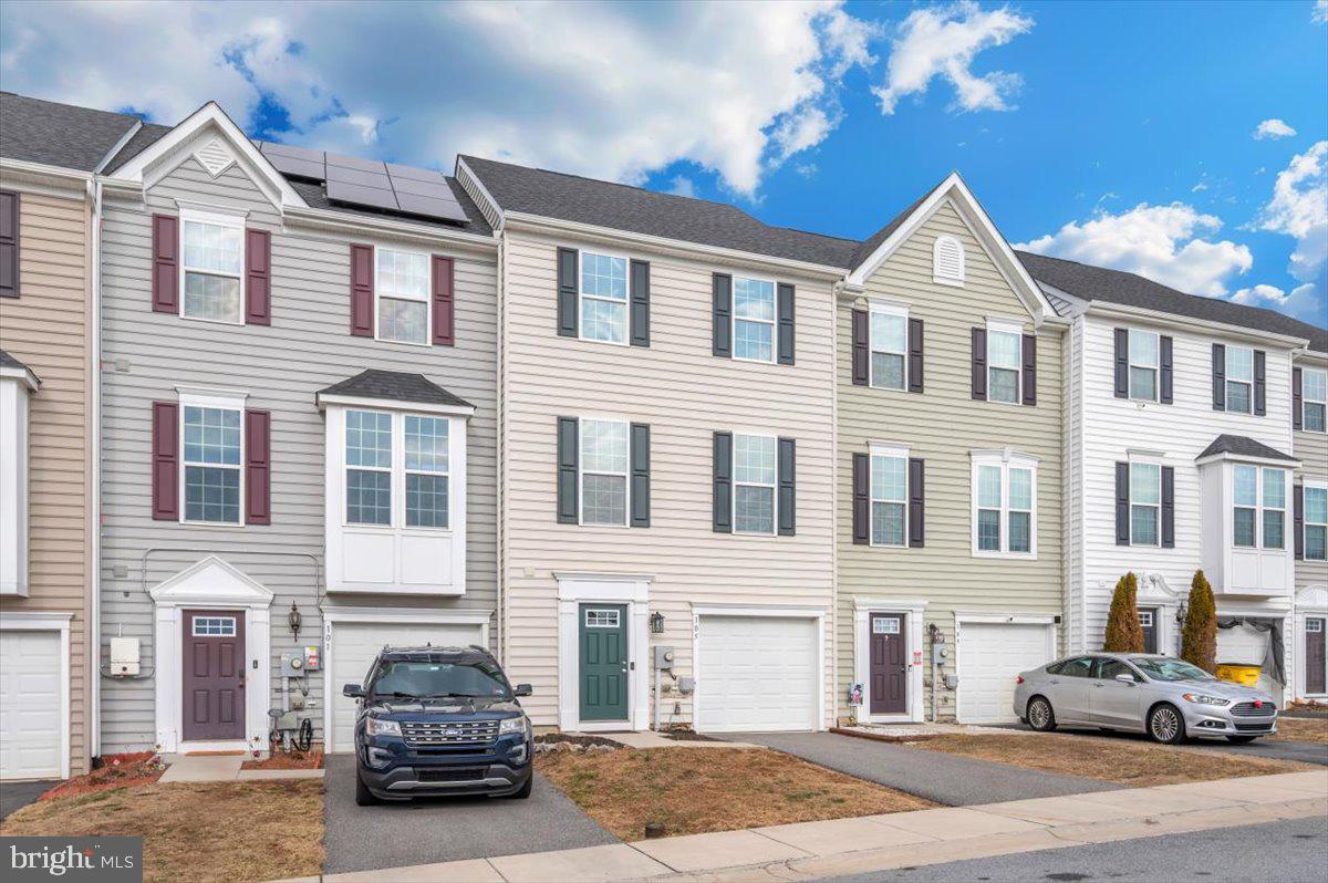 105 Montreal Way Falling Waters, WV 25419 - Photo 53 of 53 a car parked in front of a brick house