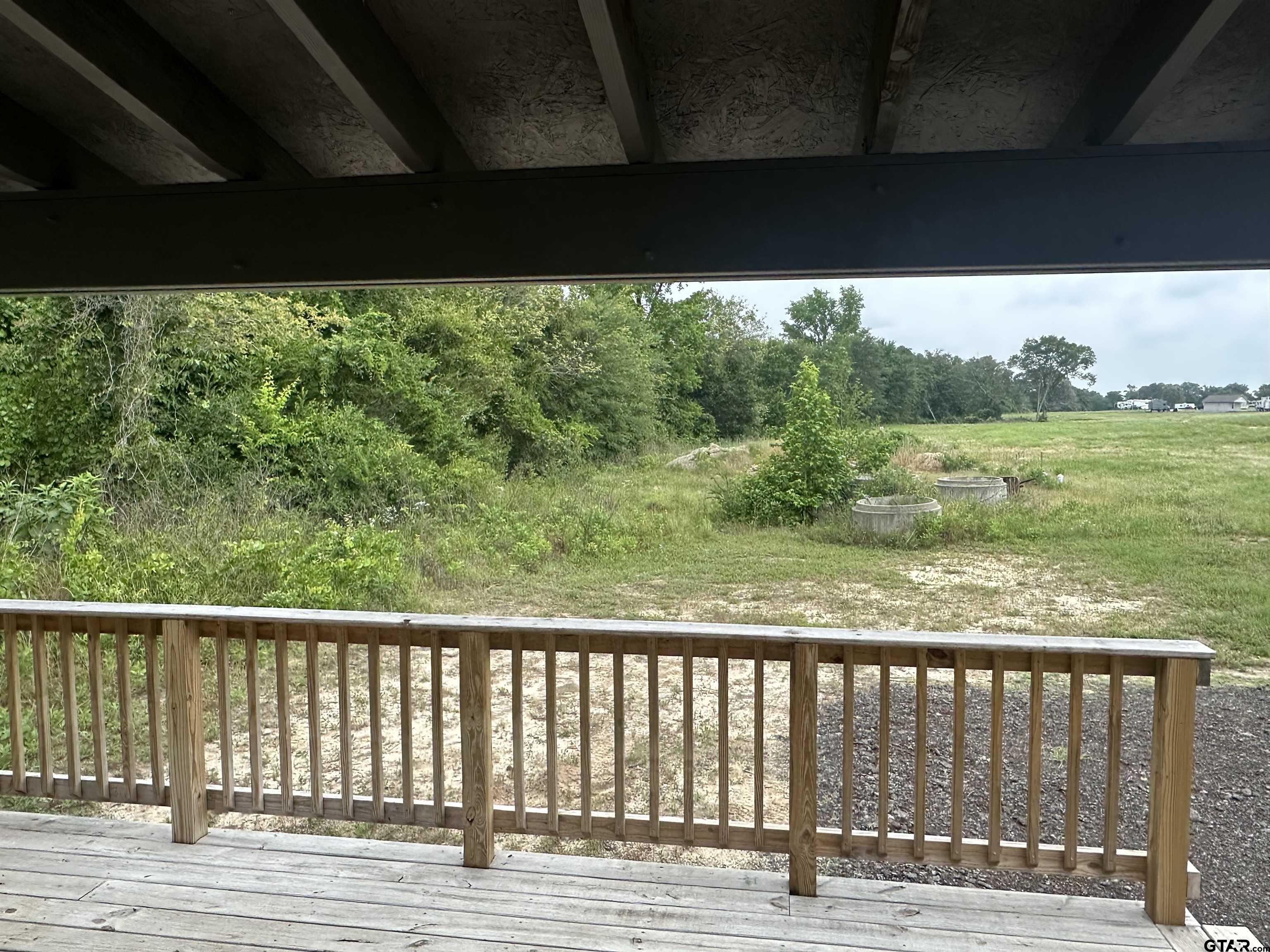 13399 Lot 99 Creek Tyler, TX 75704 - Photo 2 of 5 a view of balcony with yard and mountain