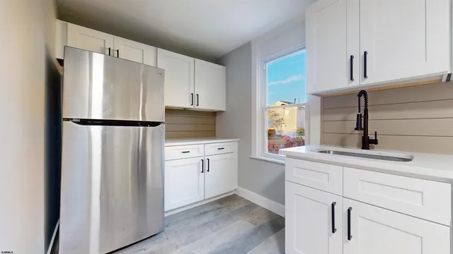 a kitchen with appliances cabinets and a sink