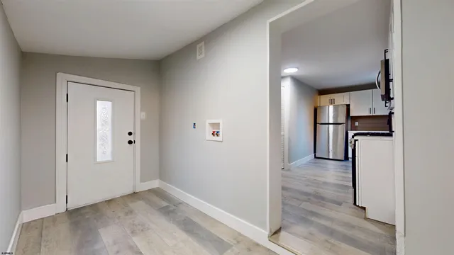 a view of a kitchen with a refrigerator a stove top oven