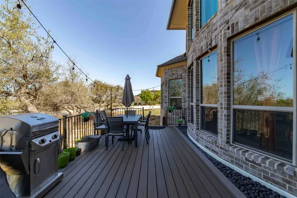 a view of a balcony with chairs and wooden floor