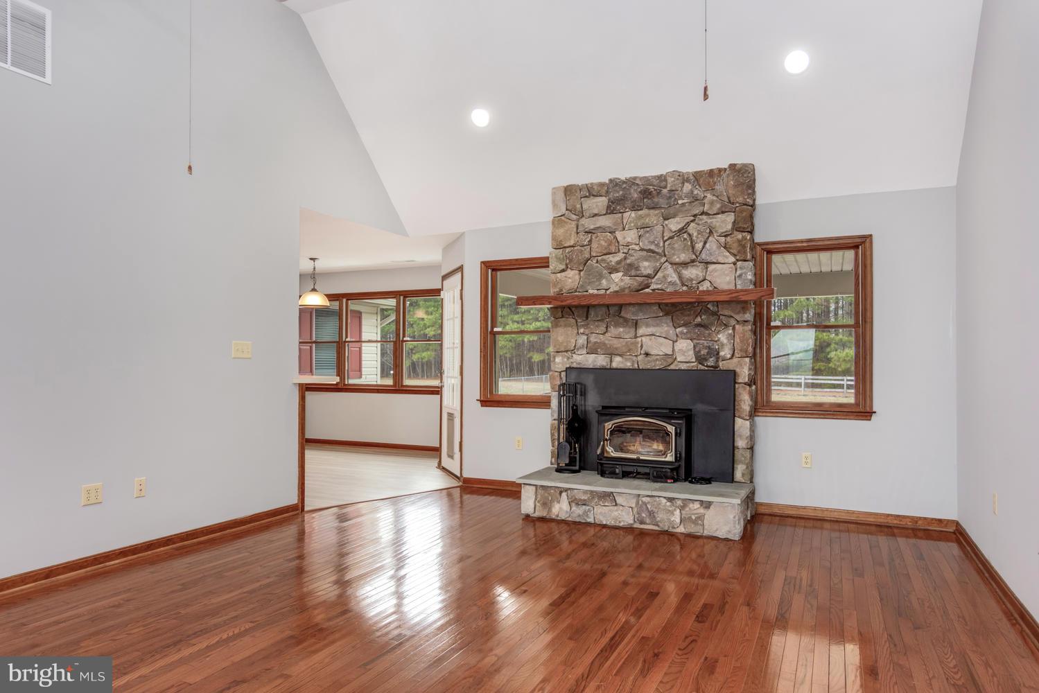 12168 Holly Road Ridgely, MD 21660 - Photo 3 of 46 Living Room w/stone FP w/woodstove insert