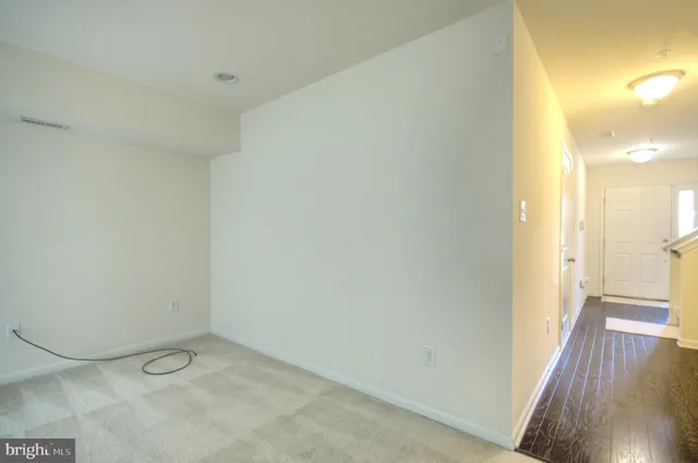 a view of a room with wooden floor and a sink